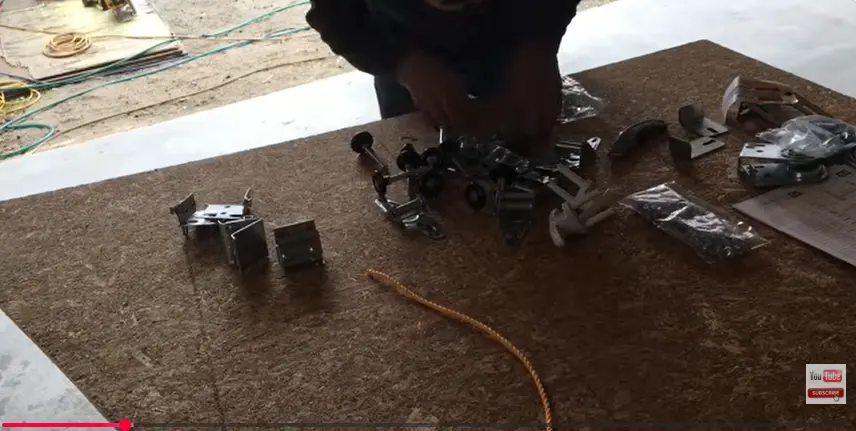 Technician working on garage door hardware components